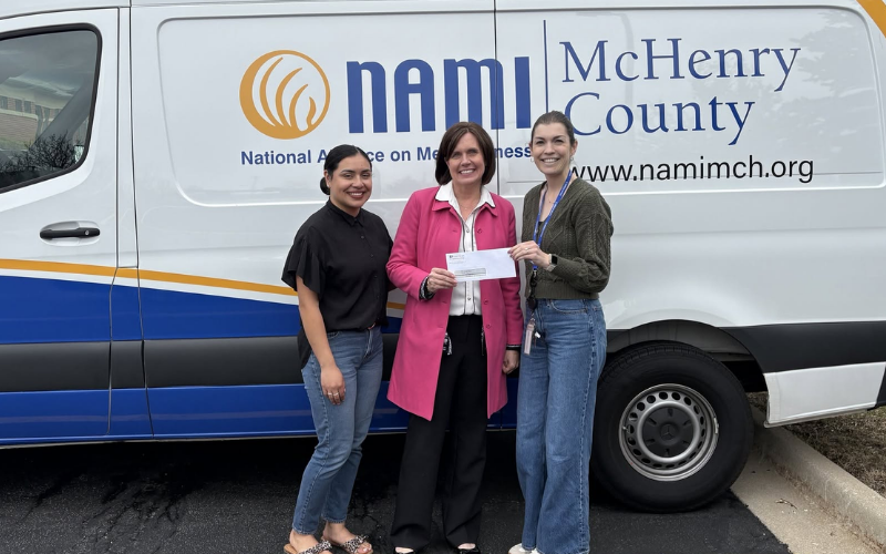 American Community Bank & Trust COO Vicki Rank presents a donation check to NAMI of McHenry County